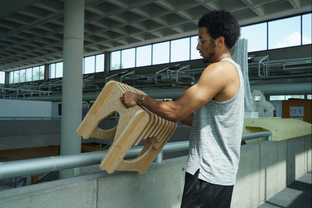Student lifting the stool off the railing