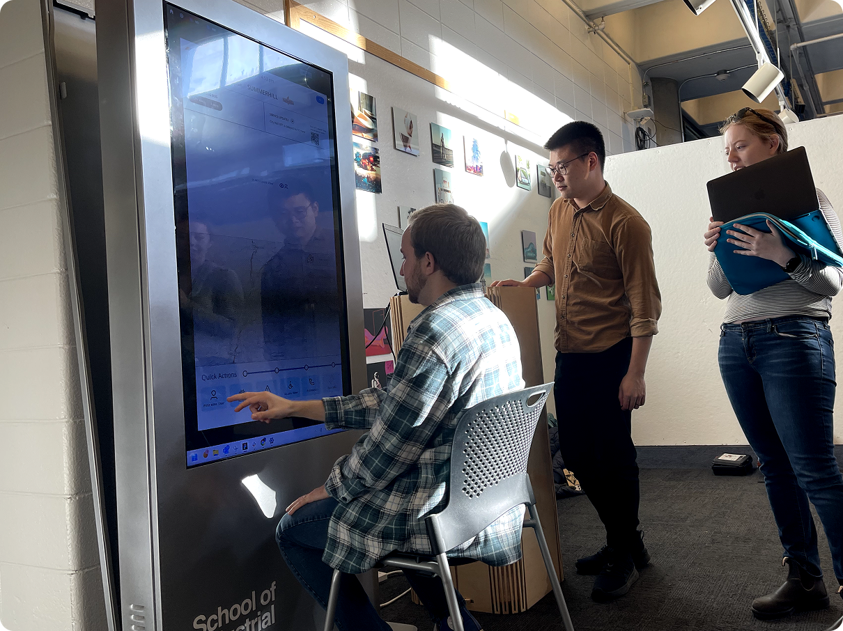 A participant testing the prototype on a large touchscreen